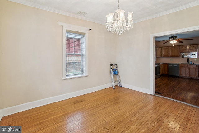 unfurnished room with a healthy amount of sunlight, ceiling fan with notable chandelier, and light wood-type flooring