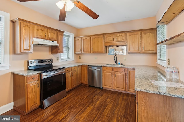 kitchen featuring ceiling fan, sink, light stone counters, dark hardwood / wood-style flooring, and appliances with stainless steel finishes