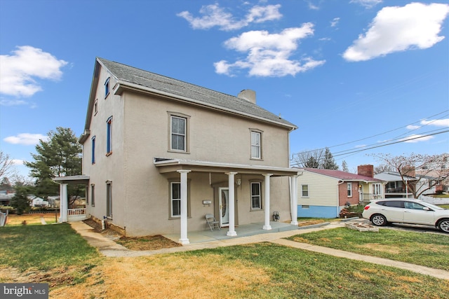 view of front of property with covered porch and a front lawn