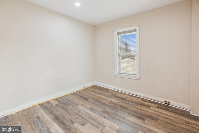 unfurnished room with wood-type flooring