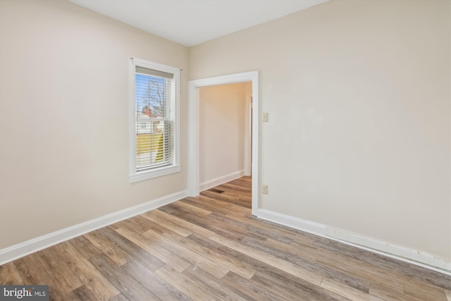 empty room with light hardwood / wood-style flooring