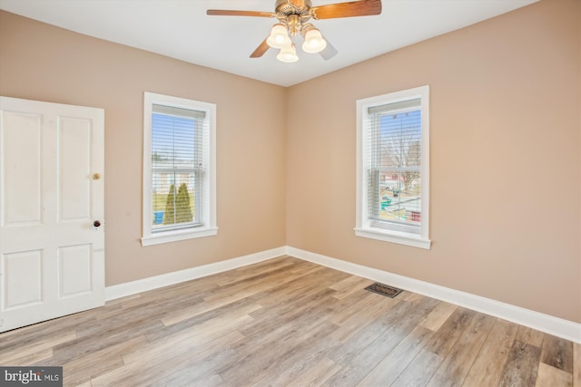 empty room featuring light hardwood / wood-style flooring and ceiling fan