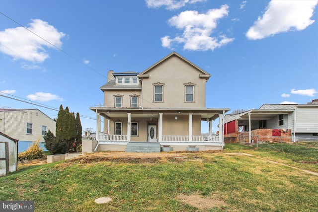 view of front facade with a front yard and a porch