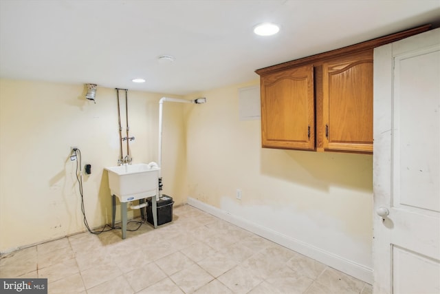 washroom featuring sink and cabinets