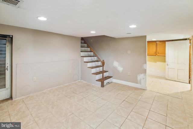 basement featuring light tile patterned floors