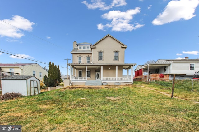 back of house with a storage unit, a porch, and a yard