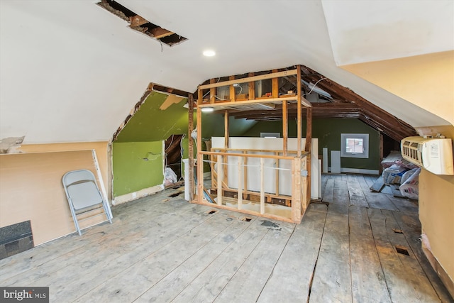 additional living space featuring hardwood / wood-style flooring and vaulted ceiling