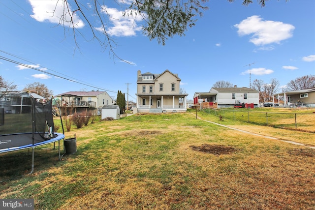 view of yard with a trampoline and a shed