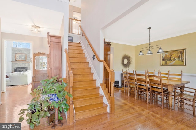 dining area with light wood-type flooring and ornamental molding