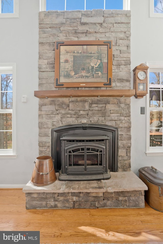 room details featuring hardwood / wood-style flooring and a wood stove