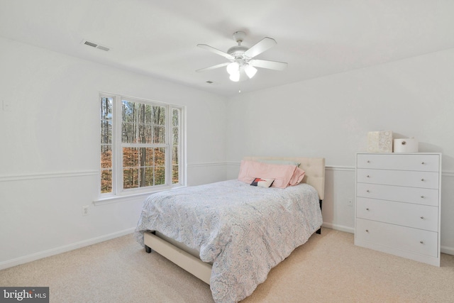 bedroom with ceiling fan and light carpet