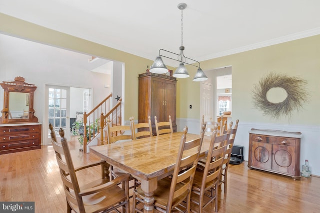 dining area with light hardwood / wood-style flooring and a chandelier