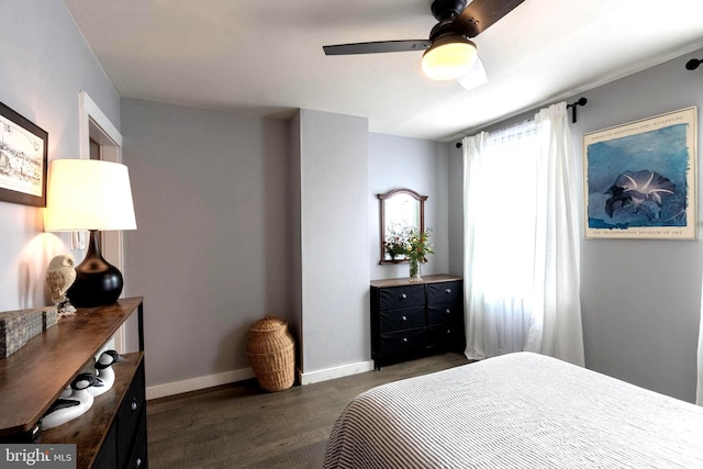 bedroom with dark hardwood / wood-style flooring and ceiling fan