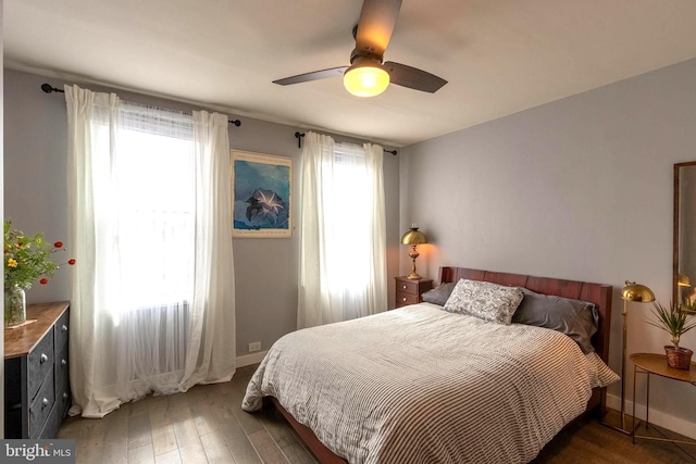 bedroom with ceiling fan and dark wood-type flooring