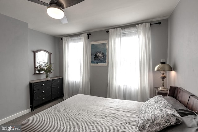 bedroom with ceiling fan and dark hardwood / wood-style flooring