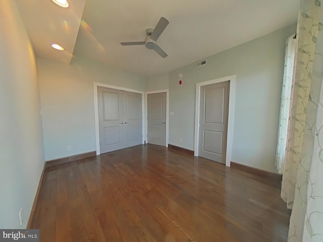 unfurnished bedroom with dark hardwood / wood-style flooring and ceiling fan