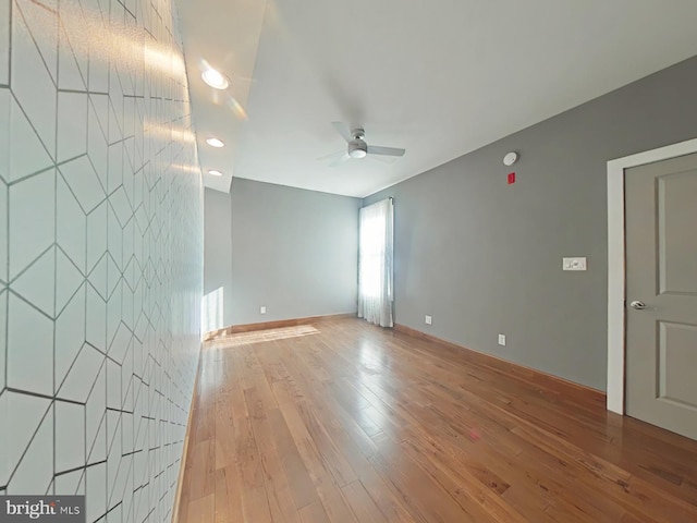 spare room featuring ceiling fan and light hardwood / wood-style floors