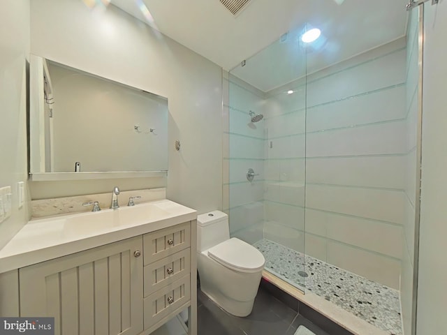 bathroom with tile patterned floors, vanity, toilet, and a shower