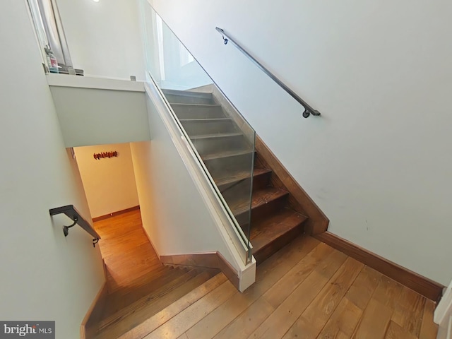 stairs with hardwood / wood-style flooring