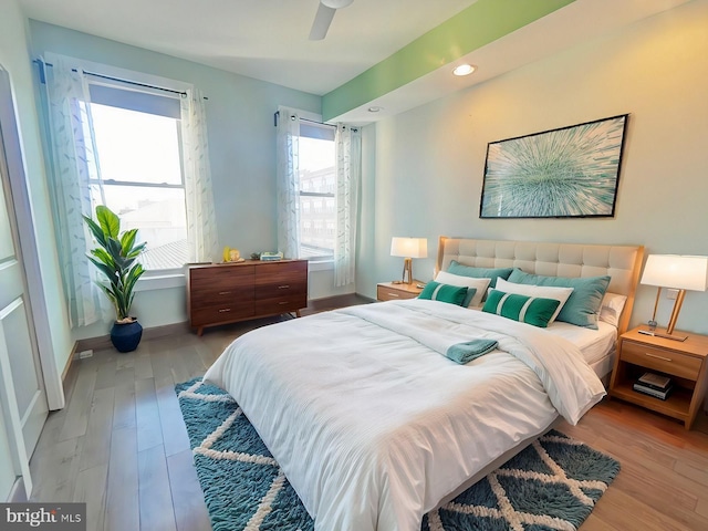 bedroom with ceiling fan and light hardwood / wood-style floors