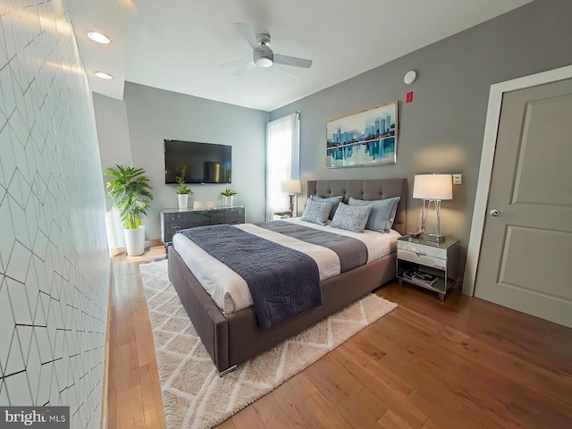 bedroom featuring wood-type flooring and ceiling fan