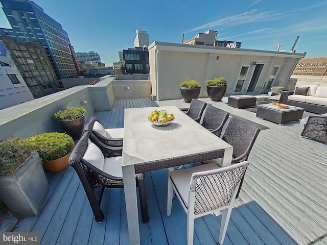 wooden deck featuring an outdoor living space with a fire pit