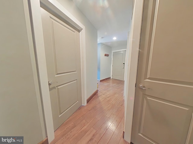 corridor with light hardwood / wood-style floors