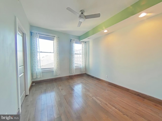 unfurnished room featuring ceiling fan and light wood-type flooring