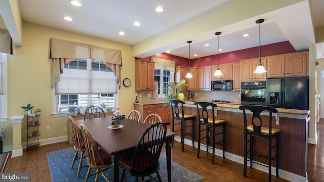 dining room with sink and dark hardwood / wood-style floors