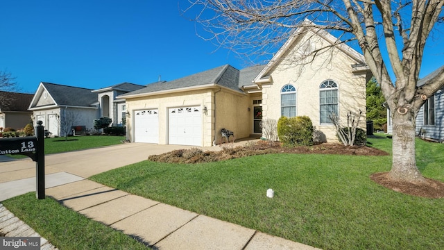 view of front of home featuring a front yard and a garage