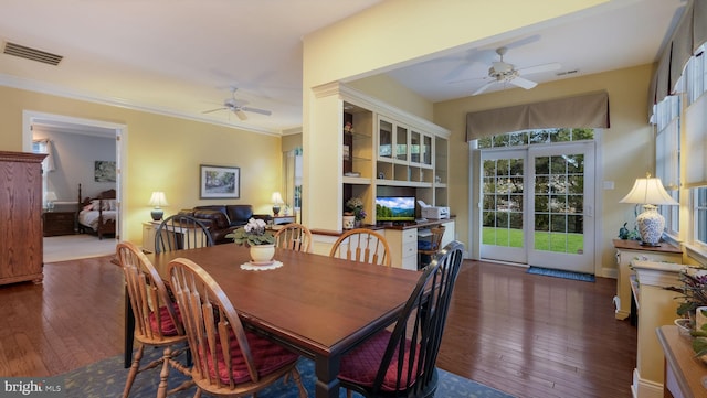 dining space with ceiling fan, ornamental molding, and dark wood-type flooring