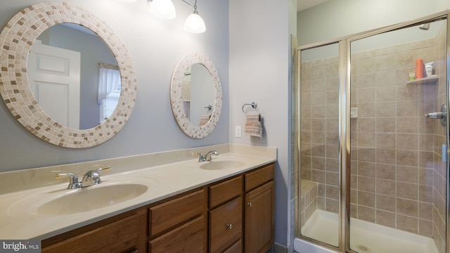 bathroom featuring vanity and an enclosed shower