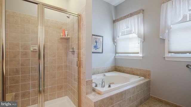 bathroom featuring shower with separate bathtub