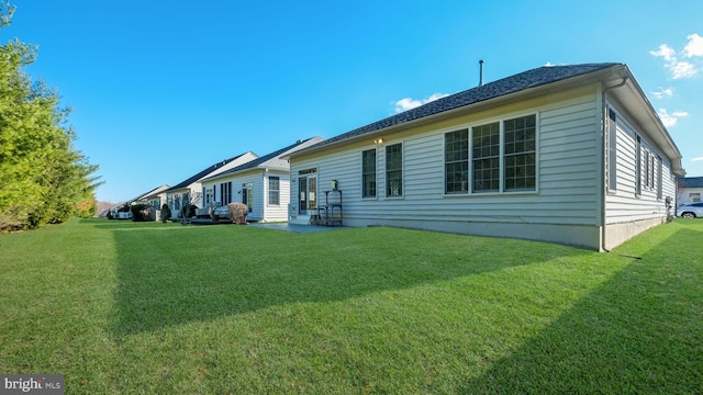 rear view of property featuring a yard