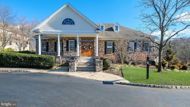 view of front of home with covered porch and a front yard