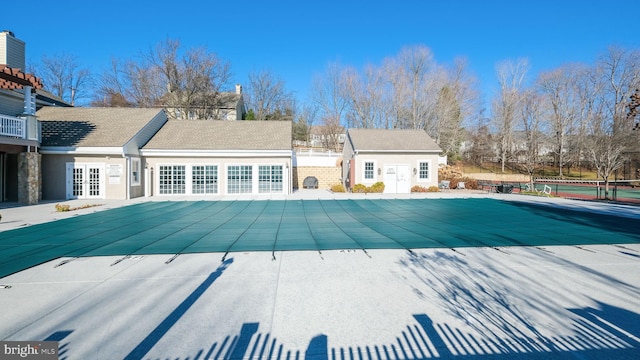 view of swimming pool featuring a patio area, an outbuilding, and french doors