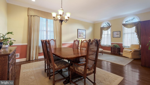 dining area featuring an inviting chandelier, dark wood-type flooring, and crown molding