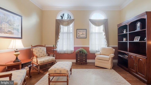 sitting room featuring hardwood / wood-style flooring and ornamental molding