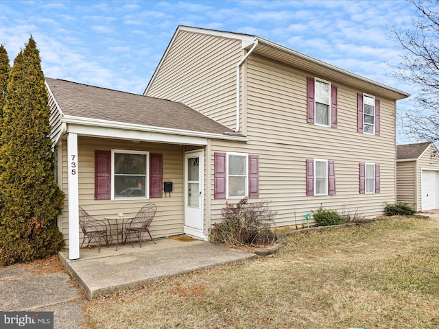 view of front of property with a patio and a front yard