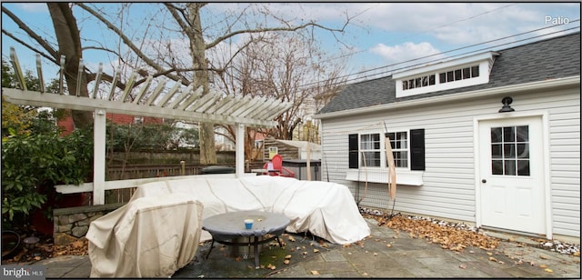 view of patio featuring a pergola and an outdoor structure