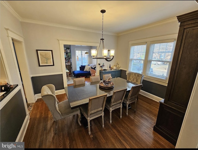 dining area featuring dark hardwood / wood-style flooring, crown molding, and plenty of natural light