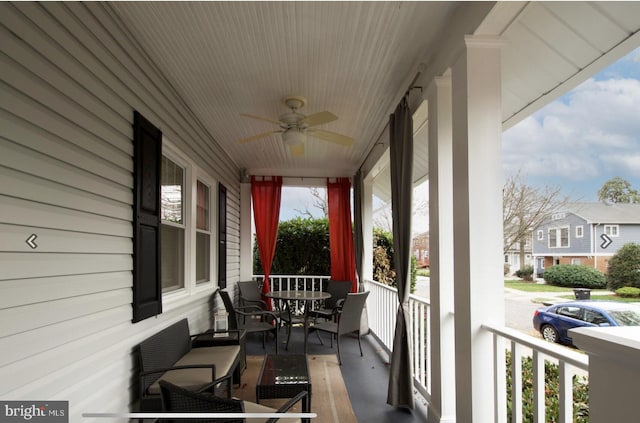 balcony featuring ceiling fan and a porch