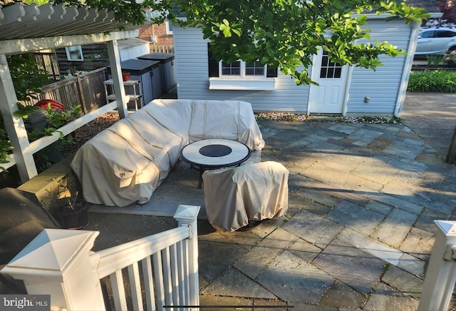 view of patio with an outdoor structure and a pergola