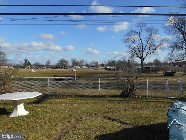 view of yard with a rural view and fence