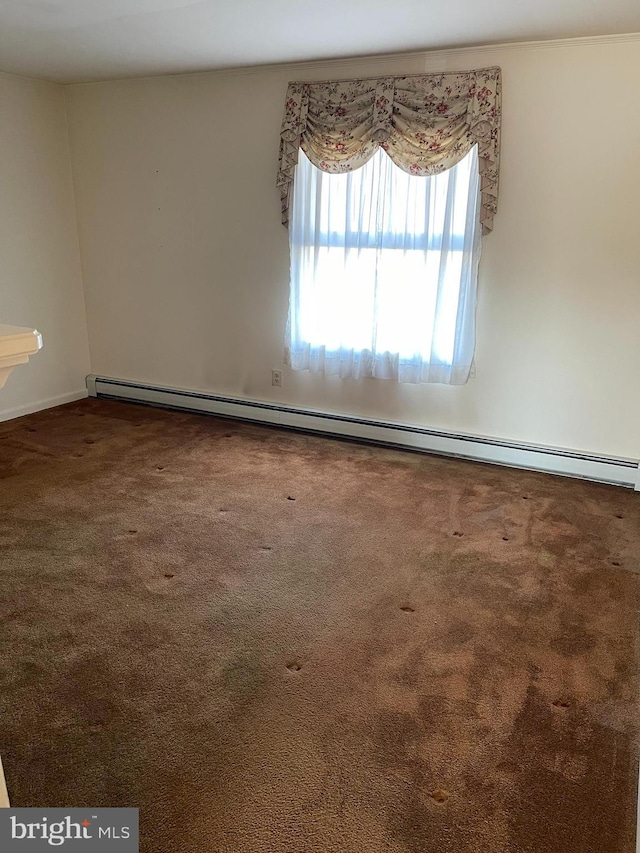 carpeted spare room with a baseboard radiator