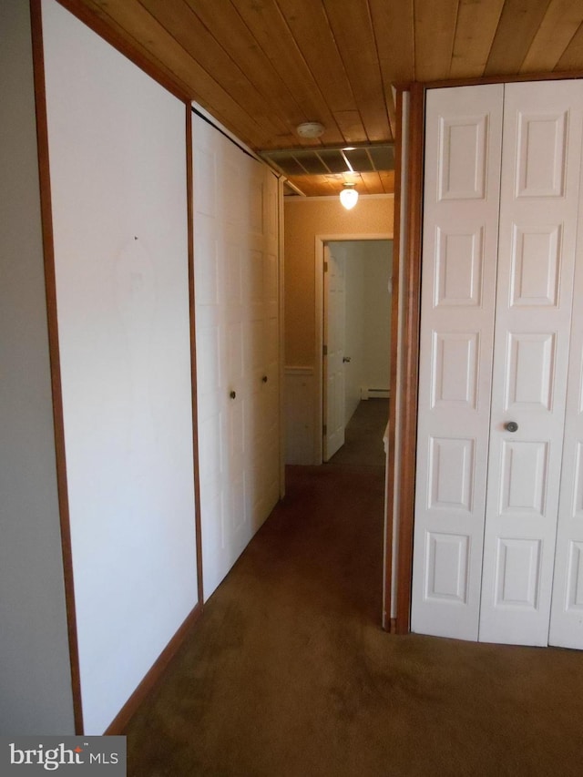 hall featuring carpet flooring and wood ceiling