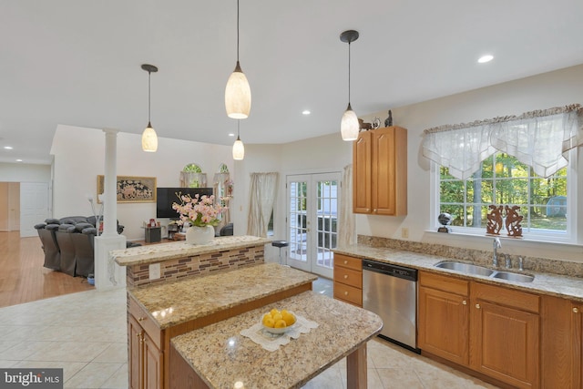 kitchen featuring decorative columns, sink, dishwasher, a kitchen island, and hanging light fixtures