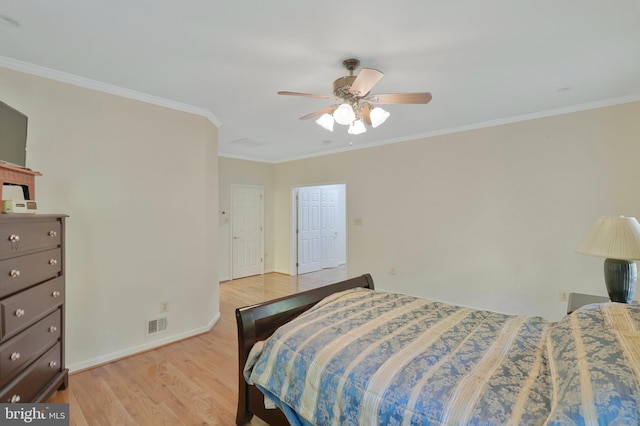 bedroom featuring ceiling fan, crown molding, and light wood-type flooring