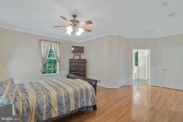 bedroom featuring ensuite bath, ceiling fan, light hardwood / wood-style flooring, and ornamental molding