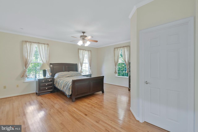 bedroom with ceiling fan, ornamental molding, and light hardwood / wood-style flooring